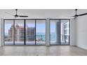 Spacious living room featuring expansive windows with stunning waterfront views at 301 Quay Commons # 1411, Sarasota, FL 34236