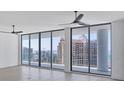 Spacious room features floor-to-ceiling glass windows providing abundant natural light and beautiful city views at 301 Quay Commons # 1411, Sarasota, FL 34236