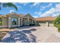 Lovely single-story home with a three car garage and paver driveway at 3336 Lakeside Cir, Parrish, FL 34219