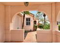 Inviting entryway through archway leading to charming home at 3814 Mira Lago Dr, Sarasota, FL 34238