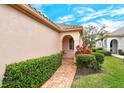 Charming home exterior with lush landscaping and brick walkway at 3814 Mira Lago Dr, Sarasota, FL 34238
