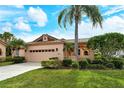 Charming single-story home featuring a tile roof, manicured lawn, and a two-car garage at 3814 Mira Lago Dr, Sarasota, FL 34238