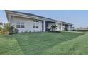 Expansive backyard featuring a covered patio, and manicured lawn at 17903 Palmiste Dr, Bradenton, FL 34202
