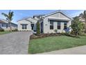 Charming home with a beautiful lawn, paver driveway, and a two car garage at 17903 Palmiste Dr, Bradenton, FL 34202