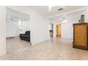 Bright and airy living room with tile flooring, ceiling fan, and neutral paint, offering a versatile living space at 2822 Maple Ave, Sarasota, FL 34234