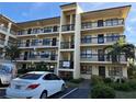 Condo building featuring multiple levels with balconies, complemented by manicured landscaping and a designated parking area at 315 30Th W Ave # 101B, Bradenton, FL 34205