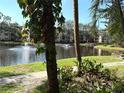Peaceful pond view with a charming fountain, framed by lush trees and greenery in a serene, park-like setting at 315 30Th W Ave # 101B, Bradenton, FL 34205
