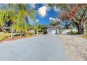 Wide driveway leading to a well-maintained single-story home with mature landscaping at 4147 Augustine Ave, Sarasota, FL 34231