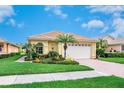 A charming home with a brick driveway, manicured lawn, and a two-car garage with a new garage door at 4244 Reflections Pkwy, Sarasota, FL 34233