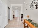 Bright entryway featuring tile flooring, accent tables, and decorative wall art at 5718 Broad River Run, Ellenton, FL 34222