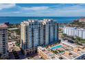 Stunning aerial view of a luxury condo building with a pool and amazing water views at 800 N Tamiami Trl # 517, Sarasota, FL 34236