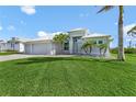 Beautifully landscaped front exterior with a well-manicured lawn and a three-car garage in a desirable neighborhood at 9464 St Marys Ct, Port Charlotte, FL 33981