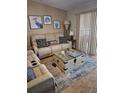 Comfortable living room features a plush sofa, patterned pillows, and neutral decor at 4553 Linwood St, Sarasota, FL 34232