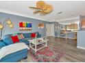 Cozy living room with stylish decor, comfortable seating, ceiling fan, and a built-in mirrored office nook at 4802 51St W St # 1811, Bradenton, FL 34210