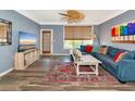 Relaxing living room showcasing a comfortable blue sofa, eclectic rug, modern television and ample natural light at 4802 51St W St # 1811, Bradenton, FL 34210