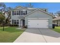 Attractive two-story home with a two-car garage, manicured lawn, and a modern architectural style at 5809 71St E St, Palmetto, FL 34221