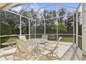 Screened-in patio with a table and chairs, perfect for outdoor dining at 8134 Coates Row Pl, Bradenton, FL 34201