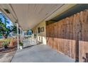 Relaxing covered porch with rocking chairs and a view of the fenced-in carport at 1206 2Nd E Ave, Bradenton, FL 34208