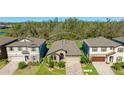An aerial view of a well-maintained single-story home with lush landscaping and a paved driveway at 12750 Oak Hill Way, Parrish, FL 34219