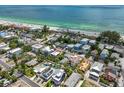 Stunning aerial view of property near a sandy beach and turquoise ocean waters at 2211 Avenue C, Bradenton Beach, FL 34217