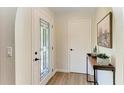 Bright entryway with decorative glass door, stylish console table, and modern accents at 3285 Datura Rd, Venice, FL 34293