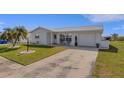 Inviting home with a well-manicured lawn, mature landscaping, and a spacious driveway leading to the garage at 3708 Chinaberry Rd, Bradenton, FL 34208