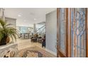 Inviting foyer with a decorative door, open staircase, and a glimpse into the open-concept home at 4473 Gulf Of Mexico Dr, Longboat Key, FL 34228