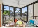 Relaxing sunroom with wicker furniture, large windows, and a bright rug at 460 S Paula Dr # 304, Dunedin, FL 34698