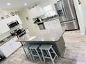 Modern kitchen featuring granite countertops, stainless steel appliances, and a breakfast bar at 7076 Nichols St, Englewood, FL 34224
