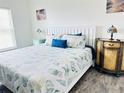 Comfortable bedroom with a white wooden bed frame, decorative pillows, and bedside tables at 7076 Nichols St, Englewood, FL 34224