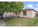 Well-maintained single-Gathering home showcasing a lush green lawn and mature landscaping at 7716 Vienna Ln, Port Richey, FL 34668