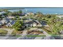 Stunning waterfront home with lush landscaping, circular driveway, and partial water views at 7912 Desoto Memorial Hwy, Bradenton, FL 34209