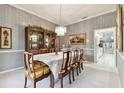 Traditional dining room with chandelier lighting and classic wallpaper at 9142 16Th Avenue Nw Cir, Bradenton, FL 34209
