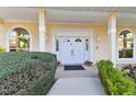 Inviting front entrance featuring a double-door entry, arched windows, and manicured shrubs at 9142 16Th Avenue Nw Cir, Bradenton, FL 34209