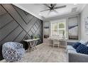 Chic sitting room with gray accent wall, patterned chair, desk, and modern decor at 13816 Messina Loop # 104, Bradenton, FL 34211