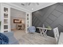 Stylish sitting area featuring a textured gray wall, patterned chair, and dining room view at 13816 Messina Loop # 104, Bradenton, FL 34211