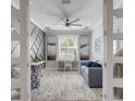 Elegant sitting room boasts gray accent wall, desk, and stylish furniture at 13816 Messina Loop # 104, Bradenton, FL 34211