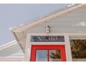Close-up showcasing the house number 'No. 310' above the bright red front door, under the eaves at 310 S Osprey Ave, Sarasota, FL 34236