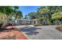 Charming single-story home featuring a spacious driveway, lush landscaping, and inviting curb appeal at 3530 Flores Ave, Sarasota, FL 34239