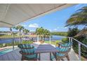 Balcony with seating overlooking the canal and lush landscaping with beautiful views at 364 El Greco Dr, Osprey, FL 34229