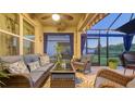Relaxing screened-in porch with comfortable seating, a ceiling fan, and a view of the backyard at 4221 Park Willow Ave, Palmetto, FL 34221