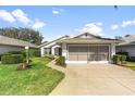 Beautifully maintained home featuring an attached two-car garage, lush lawn, and manicured shrubs at 4528 Fern Dr, Bradenton, FL 34208