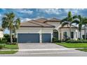 Beautiful single-story home with a tile roof, a paver driveway, and a two-car garage at 7760 Grande Shores Dr, Sarasota, FL 34240