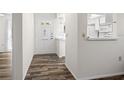 Bright entryway showcasing updated wood flooring and a clear view into the kitchen at 1022 De Soto Dr, Dunedin, FL 34698