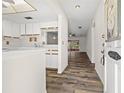 Inviting entryway featuring wood flooring and a view into the sunny living area at 1022 De Soto Dr, Dunedin, FL 34698