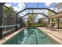 Enclosed pool with clear blue water and tiled deck, perfect for enjoying sunny days with lots of privacy at 12810 Daisy Pl, Bradenton, FL 34212