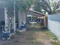 Backyard of a single Gathering home with a white picket fence and mature tree at 3305 13Th W Ave, Bradenton, FL 34205