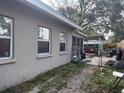 View of the house from the side yard with windows, fence, and covered lounge seating at 3305 13Th W Ave, Bradenton, FL 34205