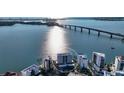 An aerial shot shows the property near a bridge, offering stunning waterfront views at 350 Golden Gate Pt # 11, Sarasota, FL 34236