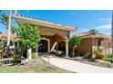 Inviting home entrance featuring an arched entryway, well-maintained walkway, and lush greenery at 542 67Th St, Holmes Beach, FL 34217